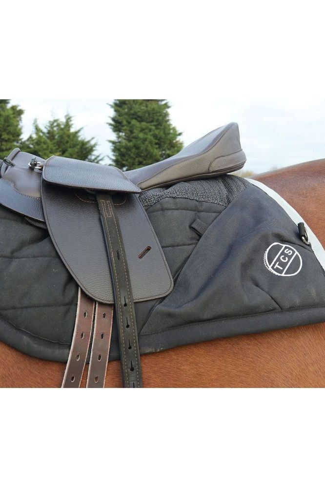 A bay horse wearing a brown classic total contact treeless saddle and a premium brown leather saddle sea