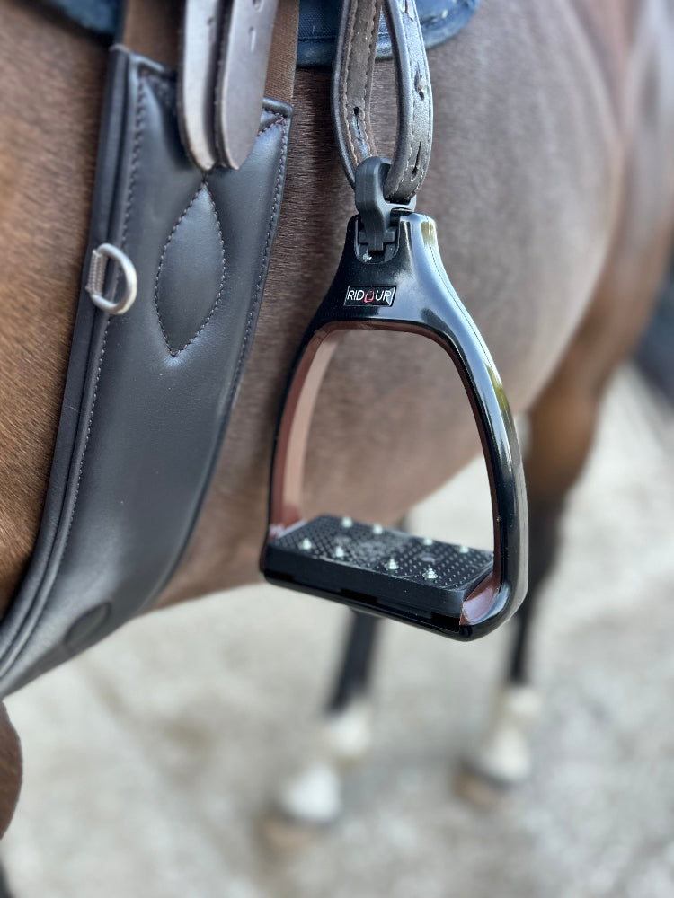 A close up of safety stirrups with a 90 degree eye which reduces bulk under the rider's leg