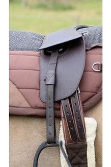 Brown TCS branded stirrup leathers on a dun horse wearing a brown classic total contact treeless saddle and a brown saddle pad
